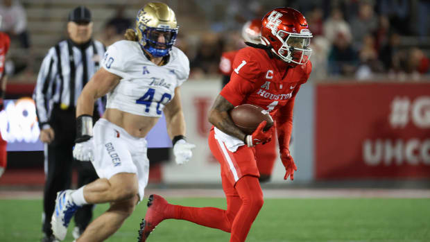 Nov 26, 2022; Houston, Texas, USA; Houston Cougars wide receiver Nathaniel Dell (1) runs with the ball during the first quarter against the Tulsa Golden Hurricane at TDECU Stadium.
